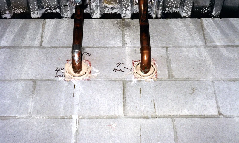 Kitchen plumbing rough-in pipes at the wall